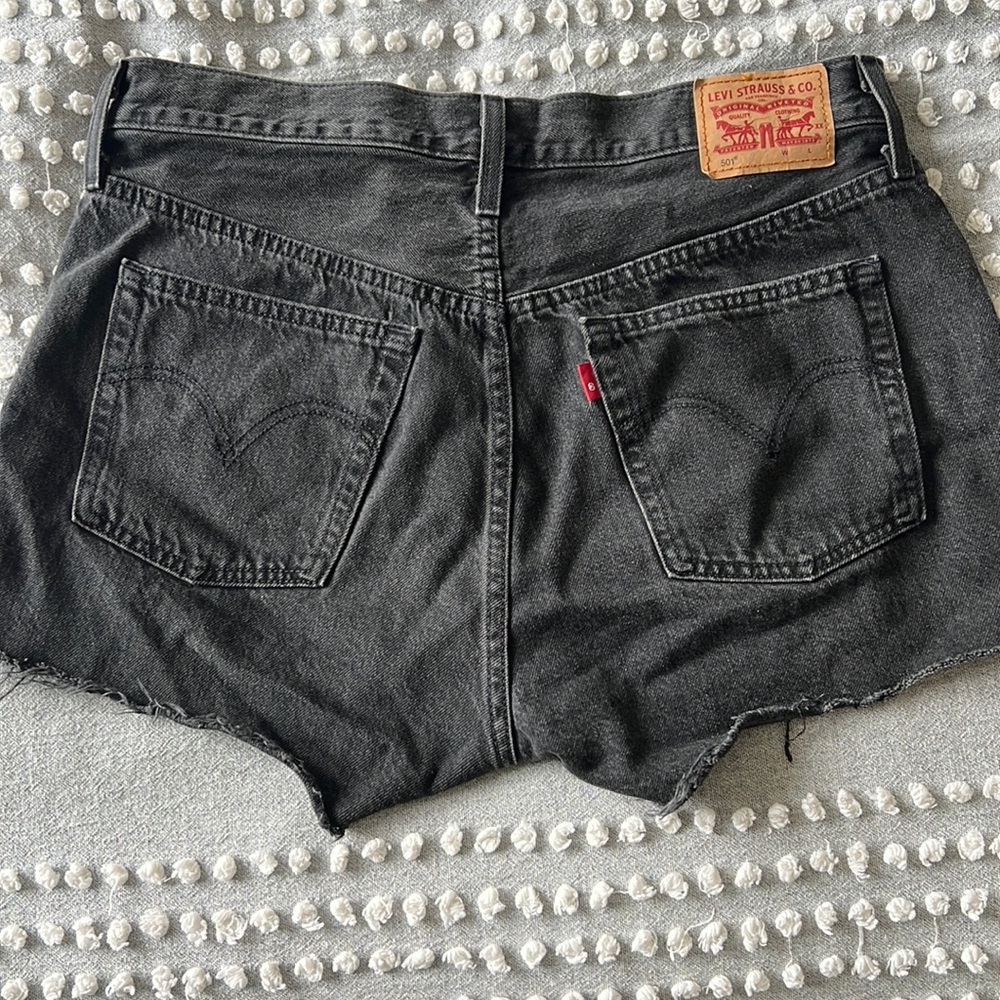Levi button fly black distressed Jean shorts. Size 30W